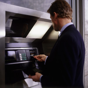 Man putting bankcard into cash machine